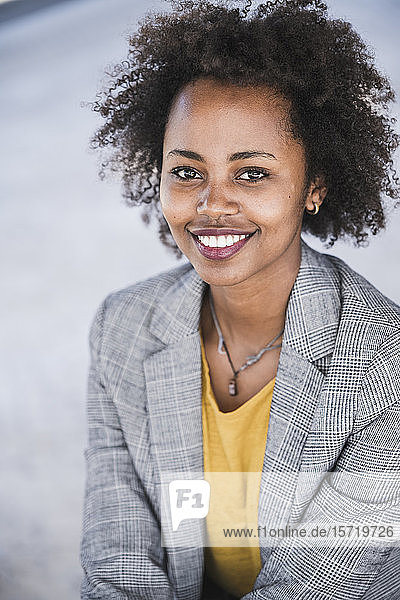Portrait of smiling young businesswoman outdoors