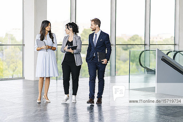 Business team with portable devices on the go