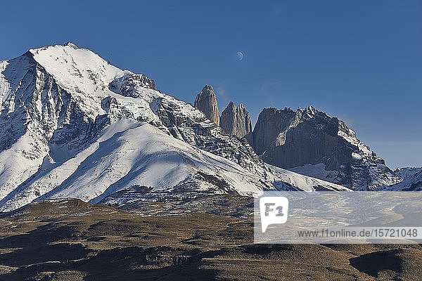 Mountain landscape  snow-covered Monte Almirante Nieto and peaks of Torre Central  Torre Monzino  Nido de Condores  above moon  Torres del Paine National Park  Patagonia  Chile  South America