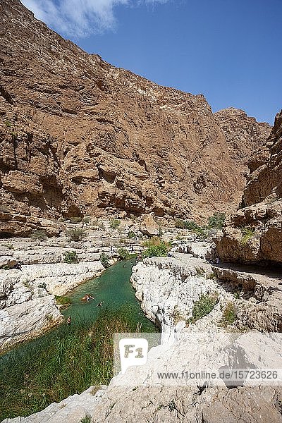 Freshwater pool between rugged cliffs  Wadi Shab  Shamal ash district Sharqiyya  Sultanate of Oman
