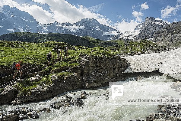 Hiking group walking at glacier stream  rear Lauterbrunnen valley  Swiss Alps Jungfrau-Aletsch  Bernese Oberland  Switzerland  Europe