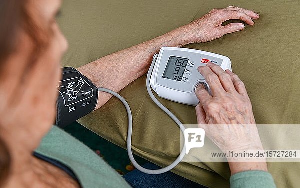 Old woman measuring blood pressure  blood pressure measurement  senior citizen  Germany  Europe