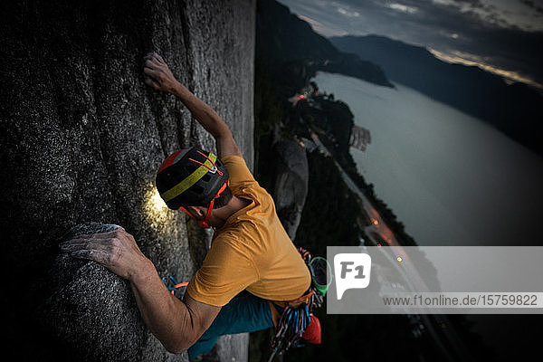 One person trad climbing at night view to the landscape below Squamish British Columbia Canada