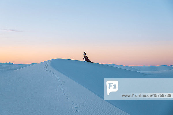 Woman on white sand dunes  White Sands National Monument  New Mexico  US