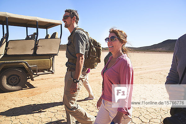 Safari tour group walking in sunny arid desert South Africa