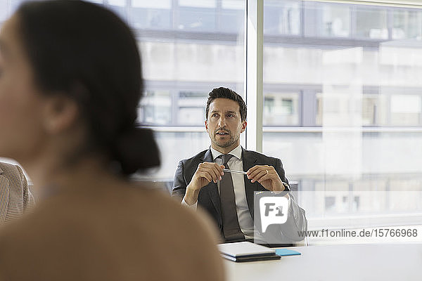 Businessman listening in conference room meeting