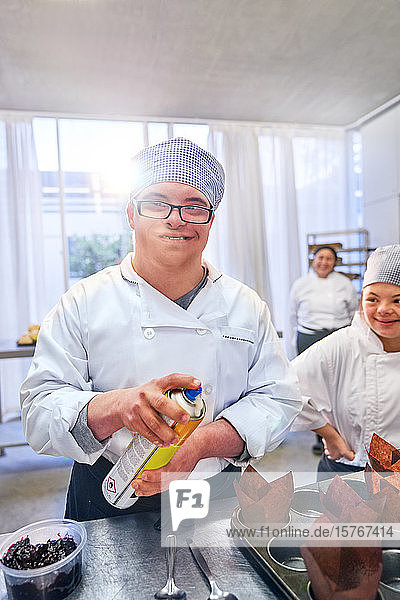 Portrait confident male student with Down Syndrome in baking class