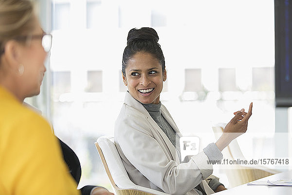 Smiling businesswoman talking in meeting