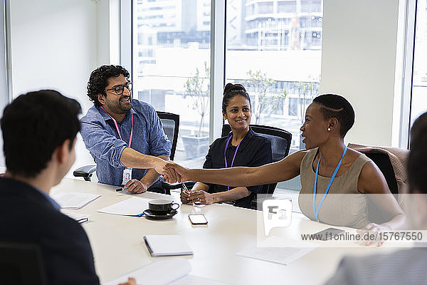 Business people shaking hands in conference room meeting