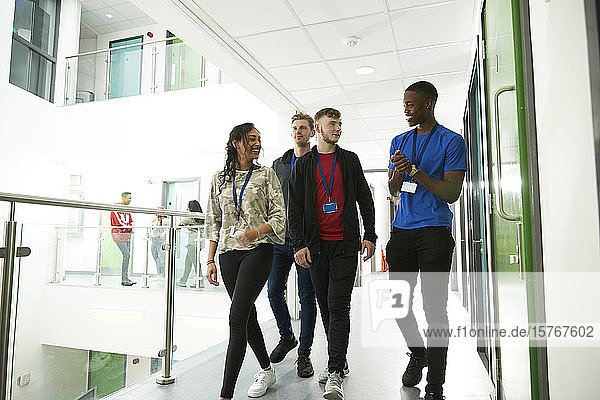 College students walking and talking in corridor