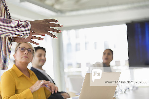 Businesswoman leading conference room meeting