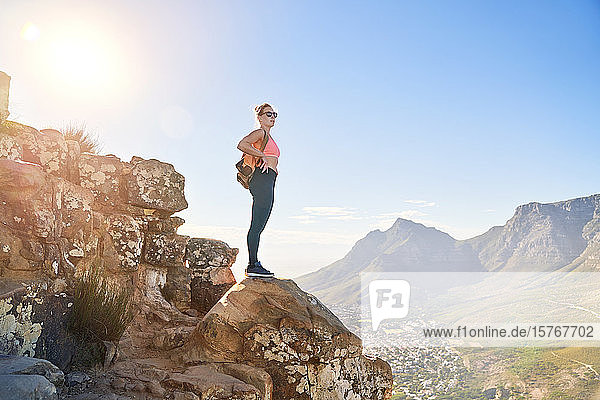 Young female hiker on sunny cliff Cape Town South Africa