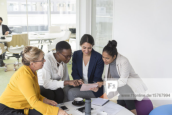 Businesswomen using digital tablet in meeting