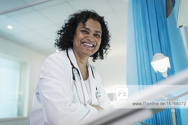 Portrait confident  smiling female doctor in hospital room