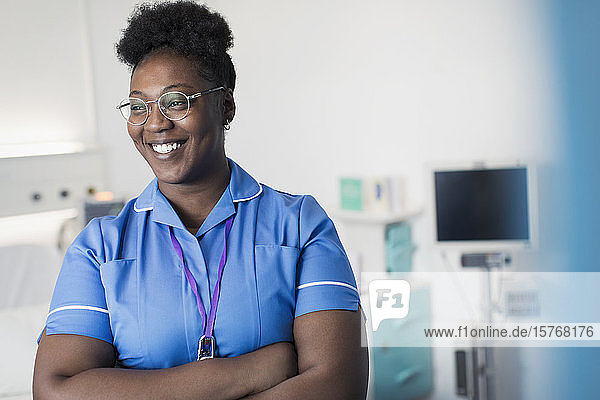 Portrait confident  smiling female nurse in in hospital room