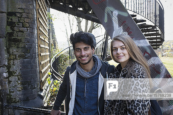 Portrait glückliches junges Paar an städtischer Treppe