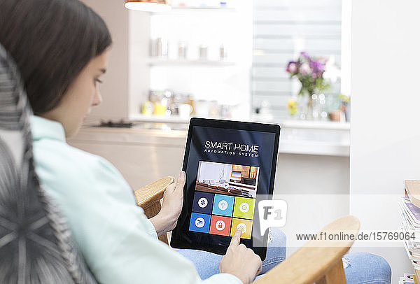 Girl using smart home automation system on digital tablet