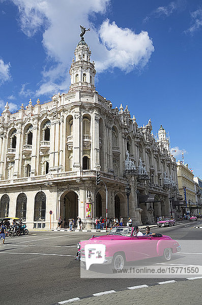 Grand Theater of Havana with old classic car driving on the street Old Town; Havana Cuba