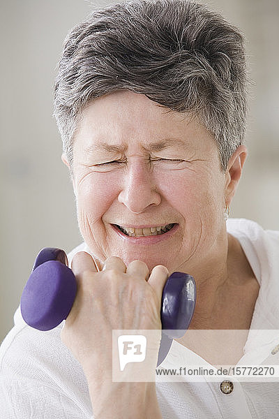 Close-up of a senior woman exercising with hand weights