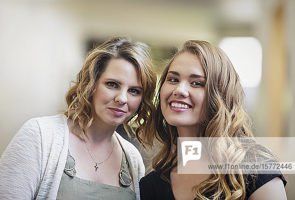 A young woman and her youth leader posing for a picture in a hallway of a church: Edmonton  Alberta  Canada