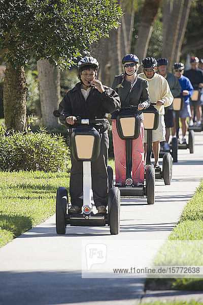 Tourists riding segways in a garden
