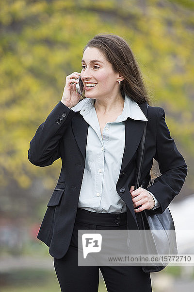 View of a business woman talking on the phone and smiling.