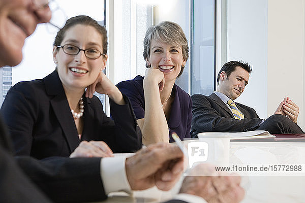 View of businesspeople smiling in an office.