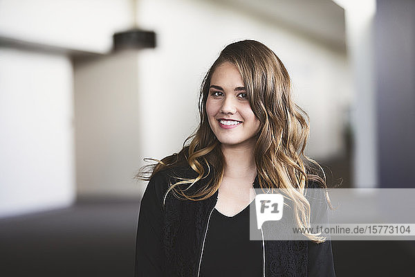 A young woman posing for a picture in a hallway: Edmonton  Alberta  Canada