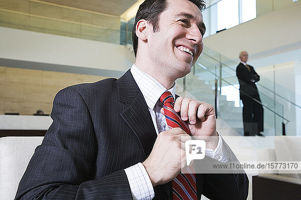 View of a smiling businessman in an office.