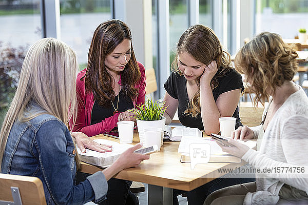 A group of women gathered together for a Bible study in a coffee shop at a church; Edmonton  Alberta  Canada