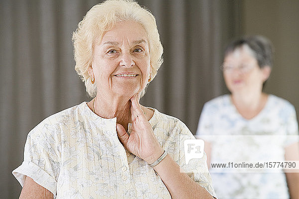 Ältere Frau überprüft ihren Puls nach dem Training in einem Fitnessstudio