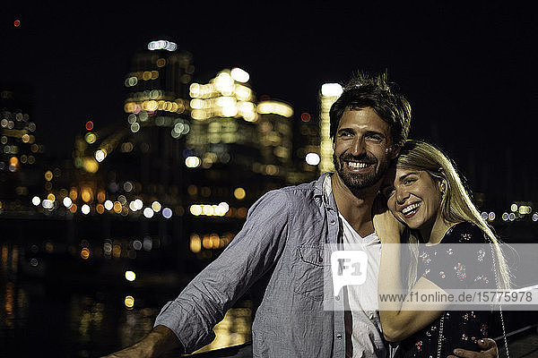 Young couple standing outdoors at night