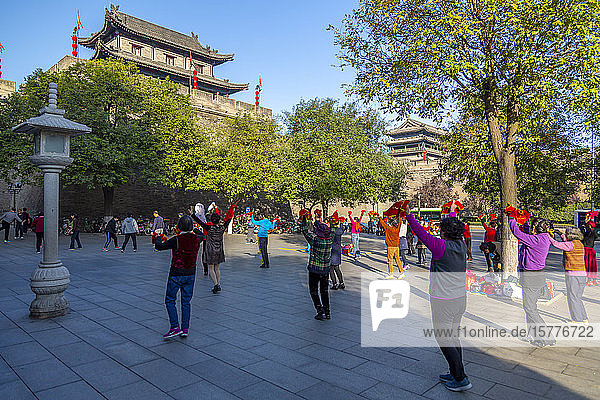 Locals performing Tai chi near City wall of Xi'an  Shaanxi Province  People's Republic of China  Asia