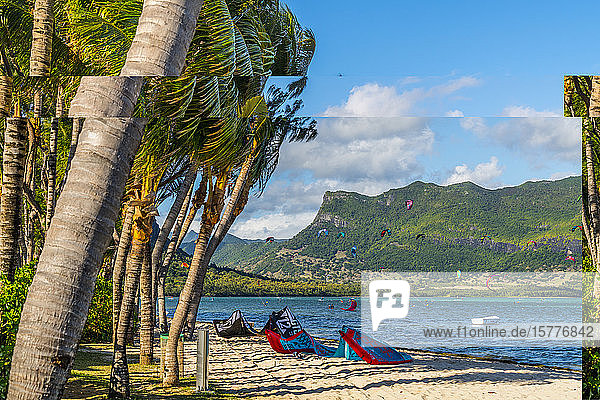 Kitesurf in the ocean seen from tropical palm-fringed beach Le Morne Brabant Black River district Mauritius Indian Ocean Africa