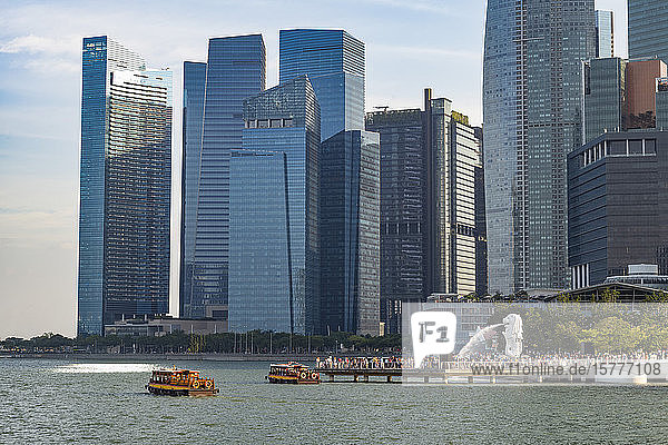 Tourist boats with the Merlion statue and Marina Bay skyline Singapore Southeast Asia Asia