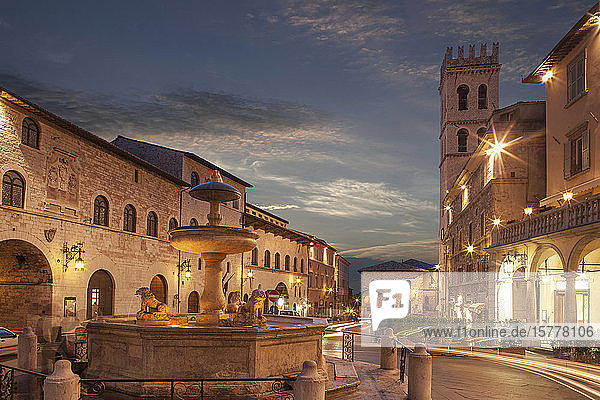 Fountain in Piazza del Comune at sunset in Assisi Italy