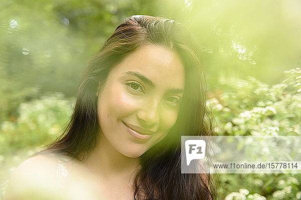 Smiling woman by bush