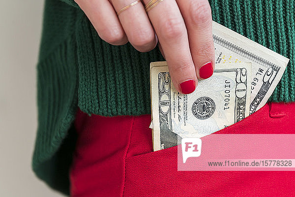 Woman putting money in pocket