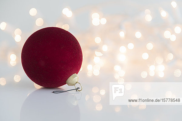 Red bauble against lights
