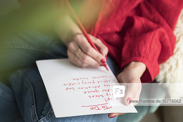 Woman writing 'to do' list
