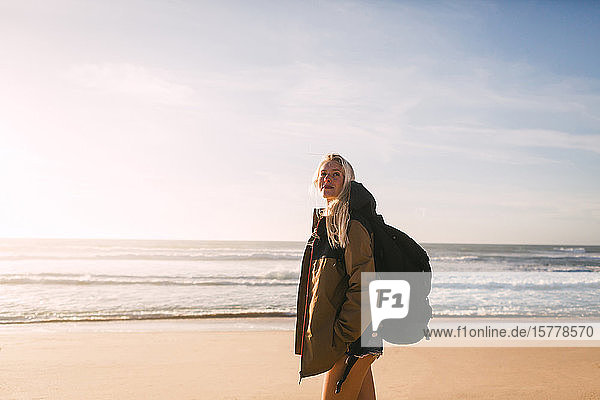 Woman wearing backpack at beach