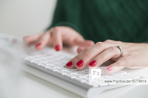 Woman typing on keyboard