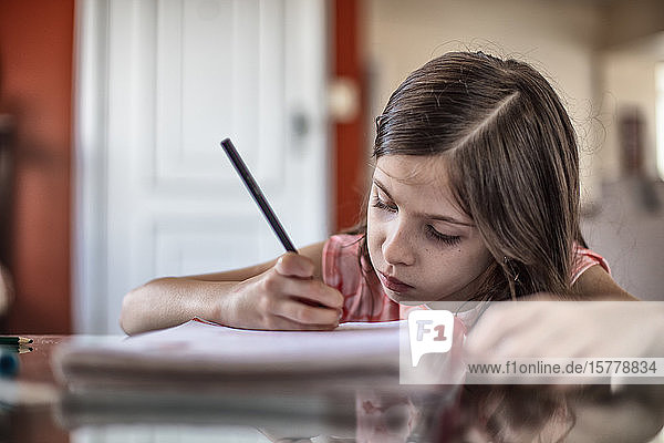 Girl writing at table