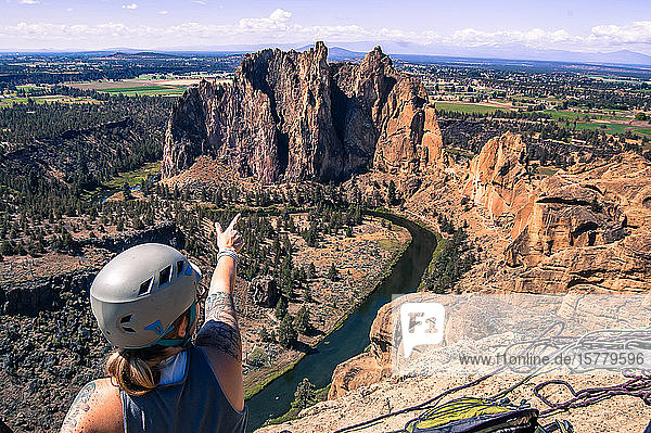 Rock climber pointing at rock formation Smith Rock State Park Terrebonne Oregon United States