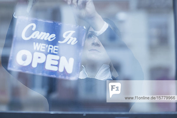 Close up of 'Open' sign in a shop window.