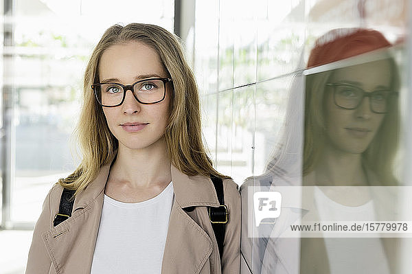Portrait of young blond businesswoman wearing glasses.