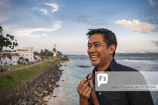 A man standing on the sea wall at Galle town on the east coast.