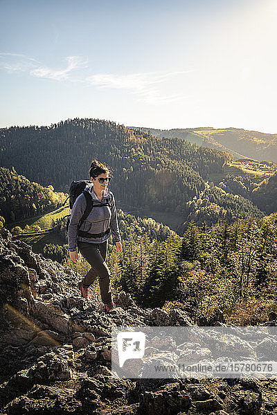 Woman hiking on rocky trail  Karlsruher Grat  Ottenhoefen  Black Forest  Germany