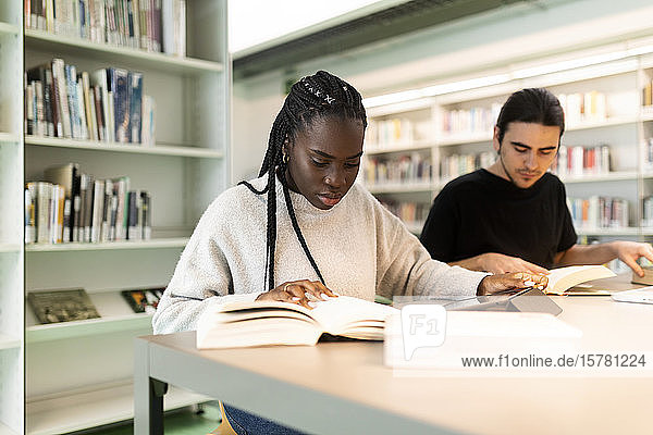 Two students learning in a library