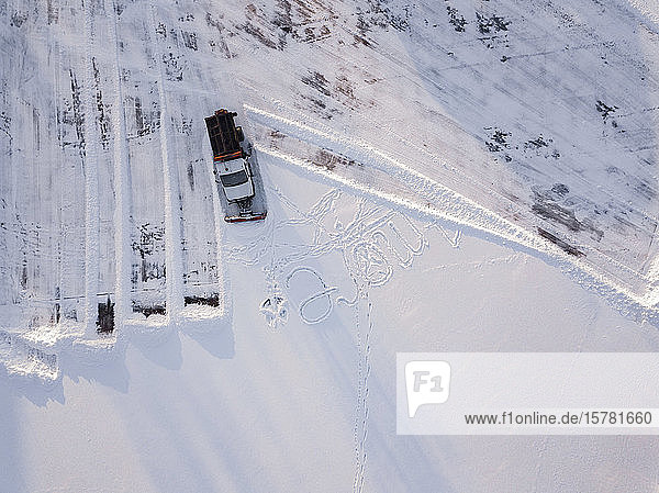 Russia Leningrad Oblast Tikhvin Aerial view of snowplow clearing parking lot